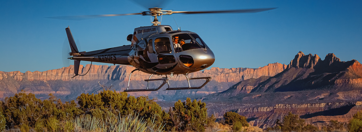 Helicopter over red rock canyon
